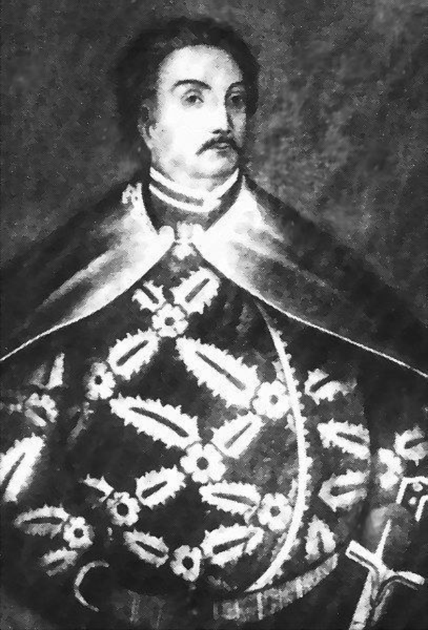 Schwarzes und weißes Foto von Papst Johannes Paul II. in Priesterrobe, der eine schwarze Robe mit weißem Kragen und Manschetten trägt, die Hände gefaltet, ernster Gesichtsausdruck und direkter Blick.
