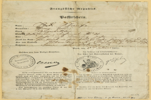 Altes vergilbtes deutsches Regierungsbrief mit einem kreisförmigen schwarz umrandeten Stempel und schwarzer Tinte.