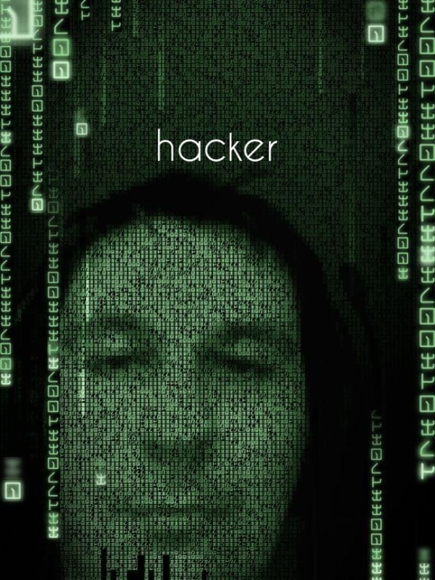 Das Gesicht eines Hackers auf einem Bildschirm mit dem Wort "Hacker" in Binärcode.